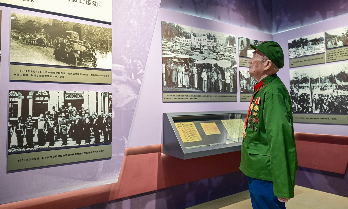 Hao Longqing, a 97-year-old veteran of the Chinese People's War of Resistance against Japanese Aggression (1931-45), visits an exhibition at the Zhejiang Provincial Archives in Hangzhou, East China's Zhejiang Province, on August 13, 2025. The exhibition is themed 