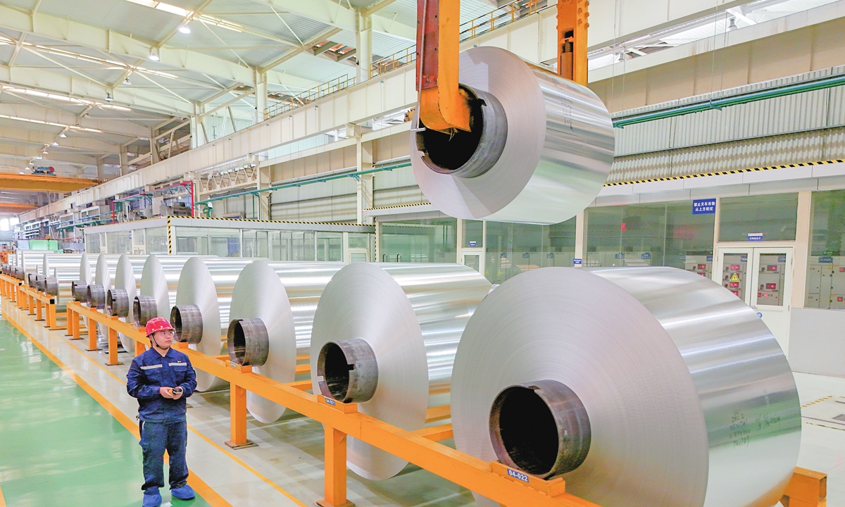 A worker is busy on an assembly line in Hezhou, South China's Guangxi Zhuang Autonomous Region on August 14, 2025. The company is ramping up production of aluminum foil products to meet market demand and striving to achieve third-quarter production targets. The company specializes in the research, development, production, and sales of electronic aluminum foil, with products mainly used in high-speed rail, 5G base stations, new-energy vehicles, and other fields. Photo: VCG