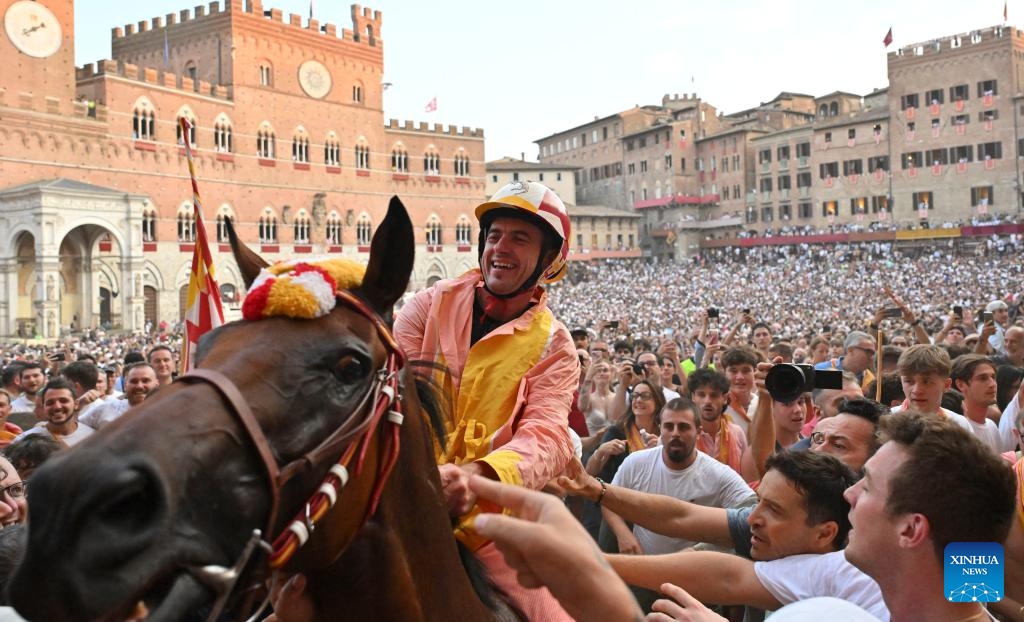 Palio jockey Giuseppe Zedde, also known as Gingillo, wins the traditional Italian horse race Palio di Siena in Siena, Italy, Aug. 16, 2025. (Photo by Alberto Lingria/Xinhua)