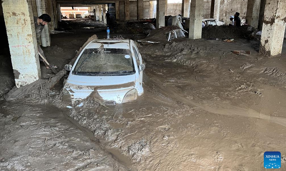 This photo taken with a mobile phone shows people struggling to retrieve vehicles from mud after floods in Buner district of Pakistan's northwestern Khyber Pakhtunkhwa province on Aug. 16, 2025. A total of 307 people were killed and scores of others injured in rain-related accidents in Pakistan's northwest Khyber Pakhtunkhwa (KP) province during the last 48 hours, the National Disaster Management Authority (NDMA) said on Saturday. (Str/Xinhua)
