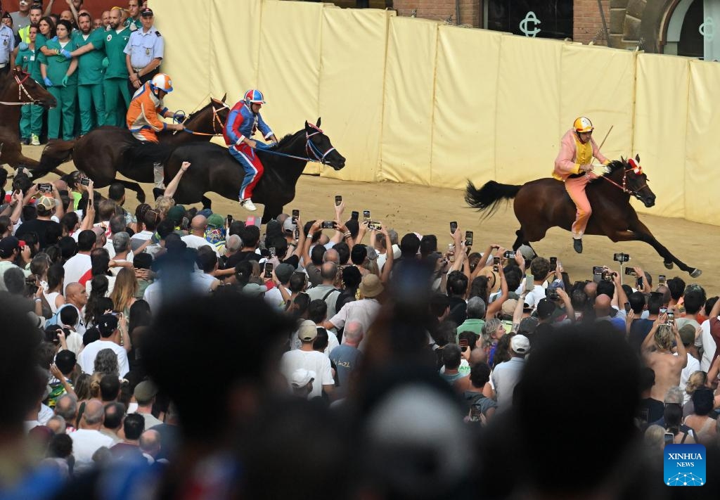 Jockeys compete during the traditional Italian horse race Palio di Siena in Siena, Italy, Aug. 16, 2025. (Photo by Alberto Lingria/Xinhua)