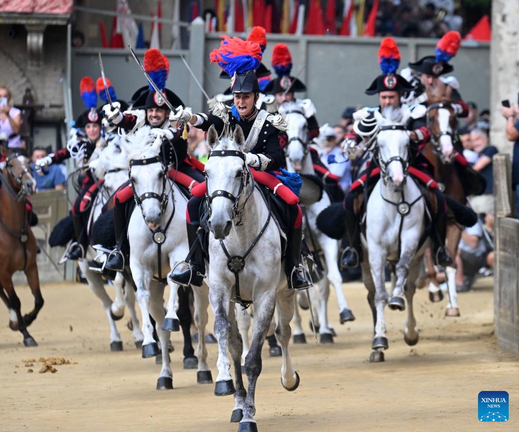 Italian Carabinieri, known as the gendarmerie of Italy, perform before the traditional Italian horse race Palio di Siena in Siena, Italy, Aug. 16, 2025. (Photo by Alberto Lingria/Xinhua)