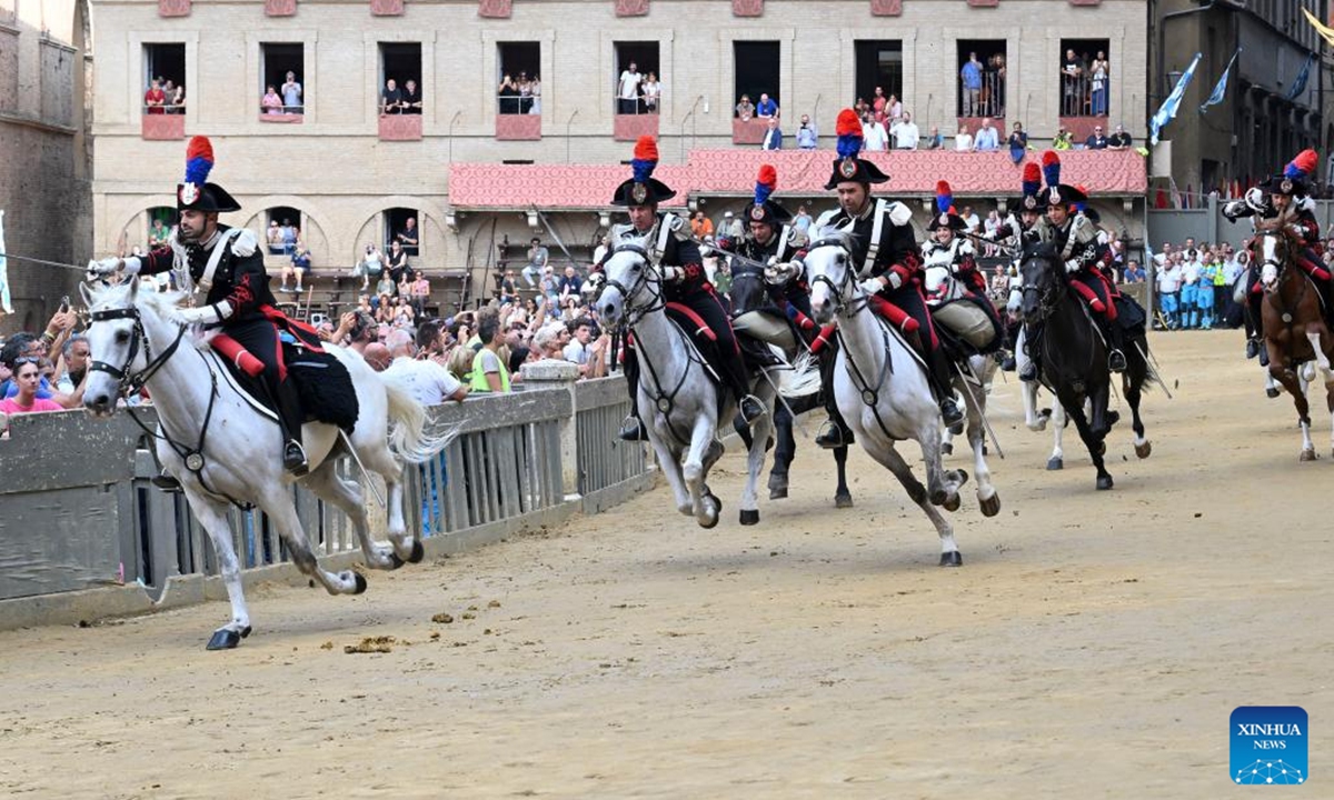 Italian Carabinieri, known as the gendarmerie of Italy, perform before the traditional Italian horse race Palio di Siena in Siena, Italy, Aug. 16, 2025. (Photo by Alberto Lingria/Xinhua)