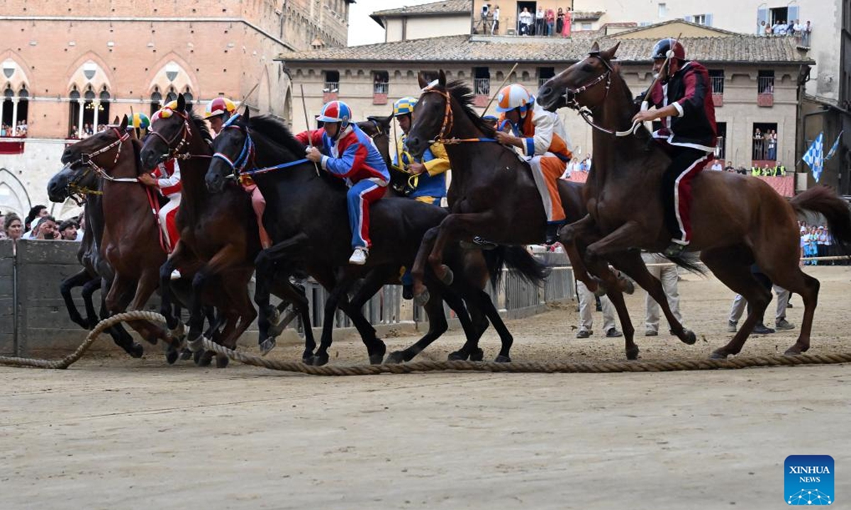 Jockeys compete during the traditional Italian horse race Palio di Siena in Siena, Italy, Aug. 16, 2025. (Photo by Alberto Lingria/Xinhua)