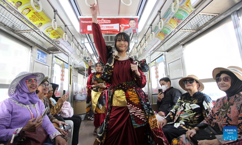 Students wearing batik stage a fashion show in a commuter train in celebration of the National Batik Day in Surakarta, Central Java, Indonesia, Oct. 2, 2025. Indonesia's National Batik Day that falls on Oct. 2 marks the United Nations Educational, Scientific and Cultural Organization (UNESCO)'s recognition on batik as an Indonesian traditional culture. (Photo by Bram Selo/Xinhua)