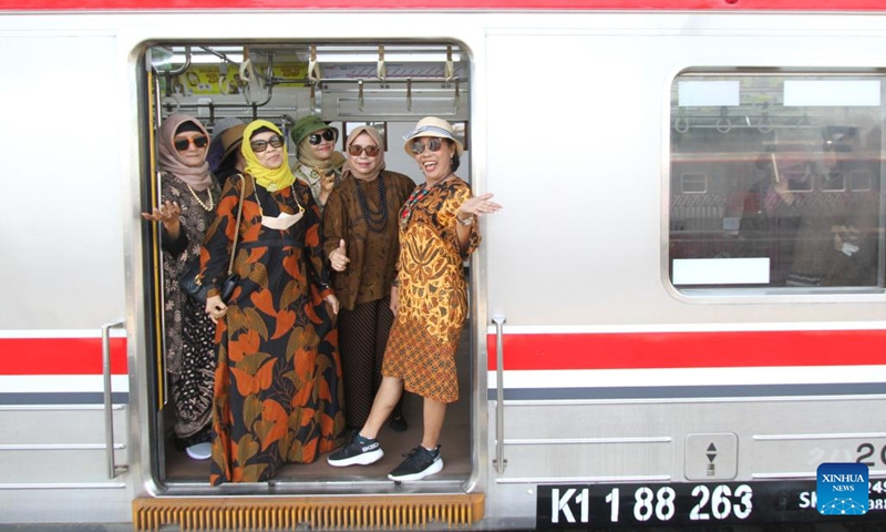 Women wearing batik pose for photos as they take a commuter train in celebration of the National Batik Day in Surakarta, Central Java, Indonesia, Oct. 2, 2025. Indonesia's National Batik Day that falls on Oct. 2 marks the United Nations Educational, Scientific and Cultural Organization (UNESCO)'s recognition on batik as an Indonesian traditional culture. (Photo by Bram Selo/Xinhua)