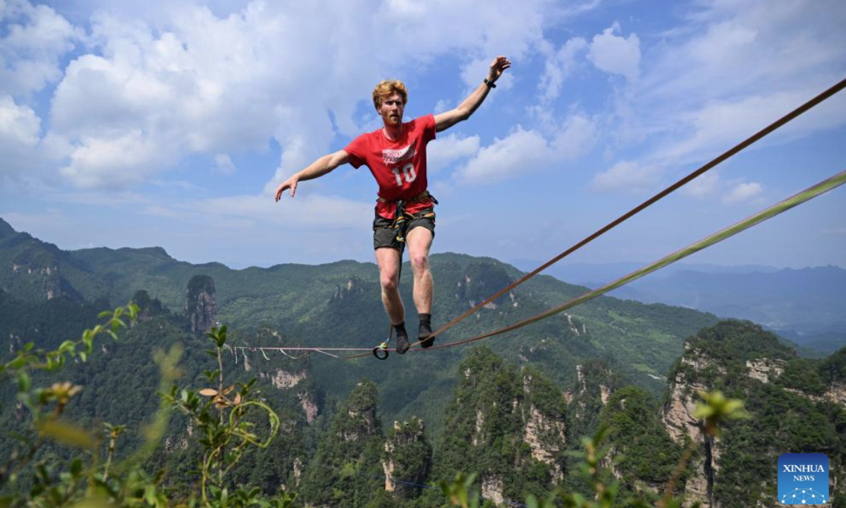 This photo taken on Aug. 18, 2025 shows Stijn of Belgium competing during the 2025 Slackline King Championship at Huangshizhai scenic spot in Zhangjiajie, central China's Hunan Province. Some 20 elite slackline athletes from China, France, Brazil, and other countries and regions competed in the event. (Photo by Guo Liliang/Xinhua)