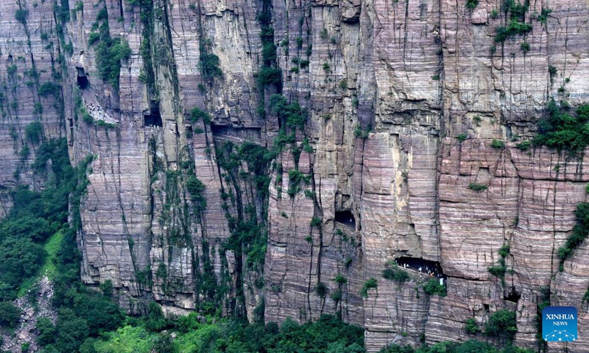 Tourists visit the Wanxianshan scenic area in Huixian City, central China's Henan Province, Aug. 16, 2025. The Wanxianshan scenic area, located deep in the Taihang Mountains and boasting its geological characters, attracts a lot of tourists in summer. (Xinhua/Zhu Xiang)