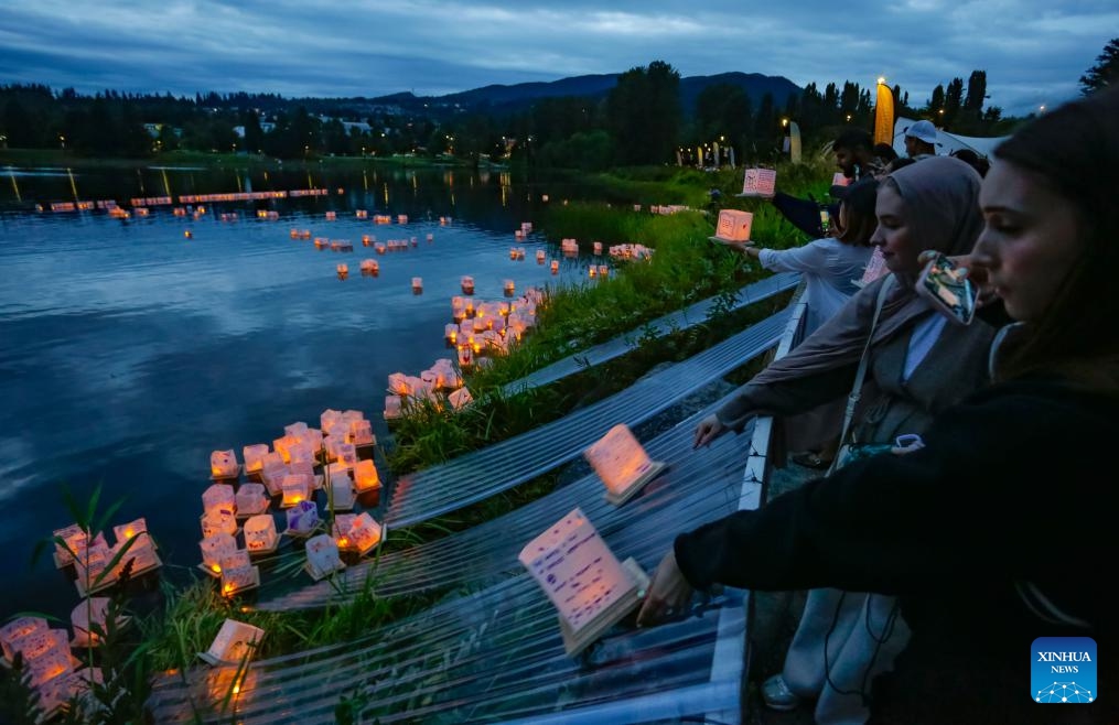 People release water lanterns on the Lafarge Lake during the Water Lantern Festival in Coquitlam, British Columbia, Canada, Aug. 16, 2025. The event attracted hundreds of residents and visitors to enjoy the illuminated lanterns and share wishes for hope and joy. (Photo by Liang Sen/Xinhua)