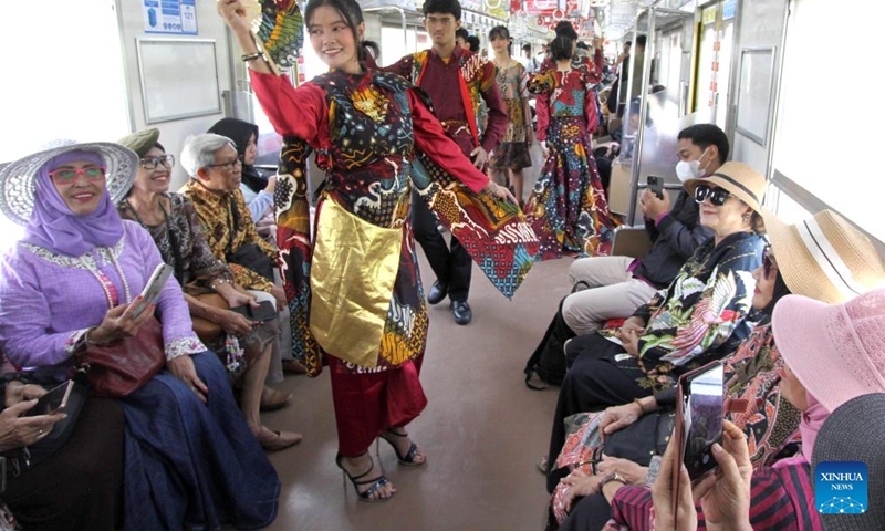 Students wearing batik stage a fashion show in a commuter train in celebration of the National Batik Day in Surakarta, Central Java, Indonesia, Oct. 2, 2025. Indonesia's National Batik Day that falls on Oct. 2 marks the United Nations Educational, Scientific and Cultural Organization (UNESCO)'s recognition on batik as an Indonesian traditional culture. (Photo by Bram Selo/Xinhua)