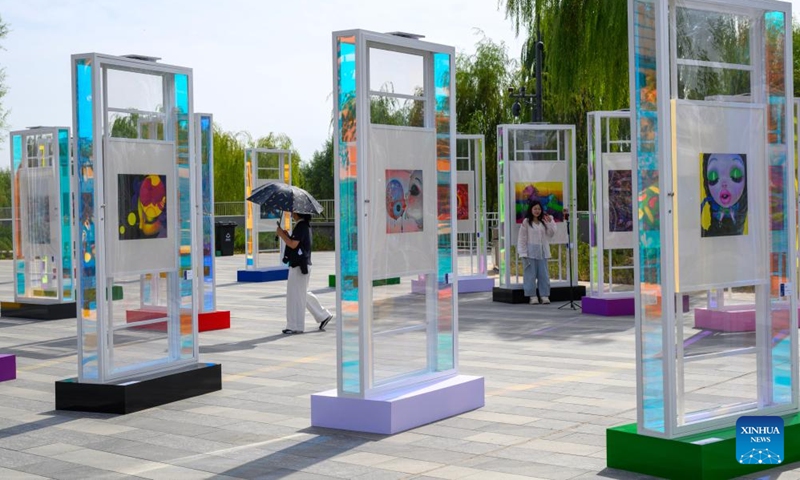 People visit an exhibition of the 2025 Grand Canal Public Art Season in Beijing, capital of China, Oct. 1, 2025. The 2025 Grand Canal Public Art Season kicked off here on Wednesday, enabling the public to experience the charm of art through interactive experiences. (Xinhua/Jin Liangkuai)