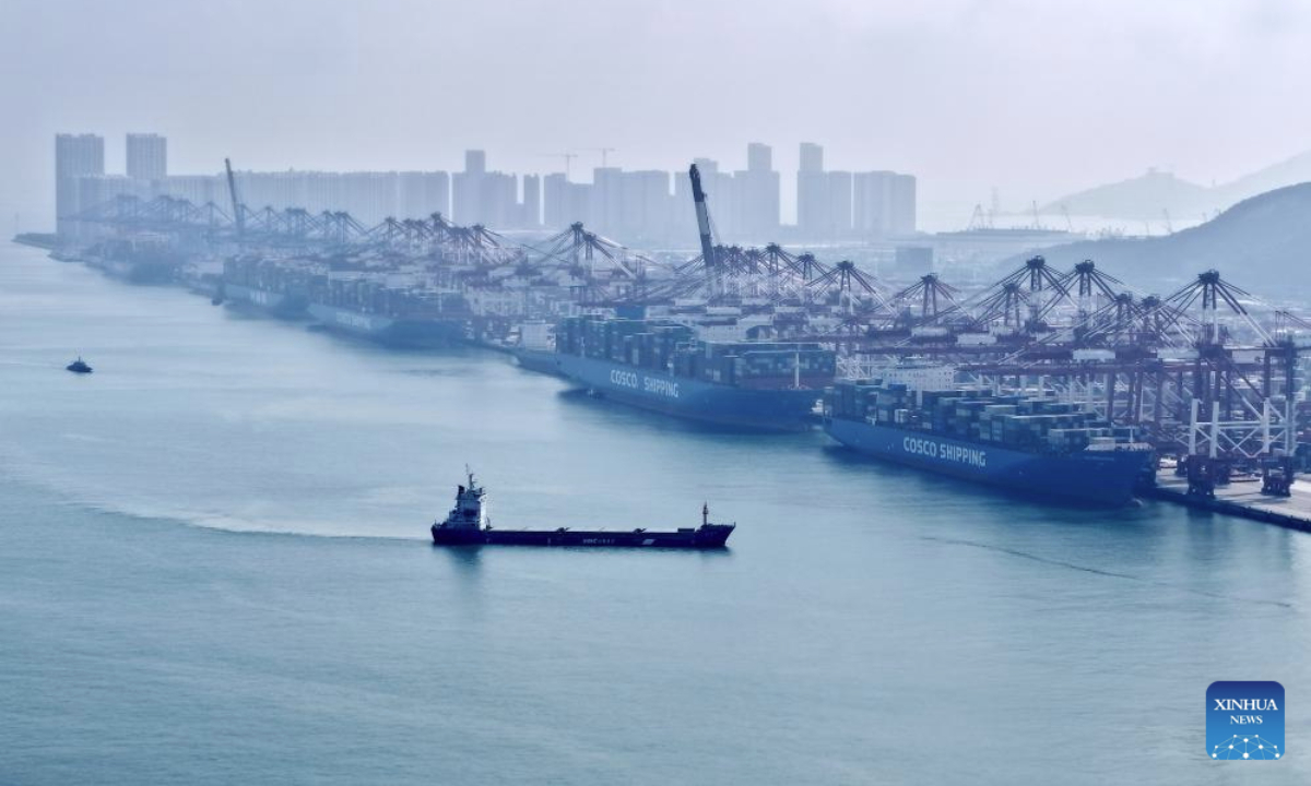 An aerial drone photo taken on Aug. 19, 2025 shows a cargo ship navigating at Qingdao Port in Qingdao, east China's Shandong Province. As of the end of July, Qingdao Port has added 22 new outbound trade routes this year, bringing its total to 233 and connecting to over 700 ports in more than 180 countries and regions. (Xinhua/Li Ziheng)