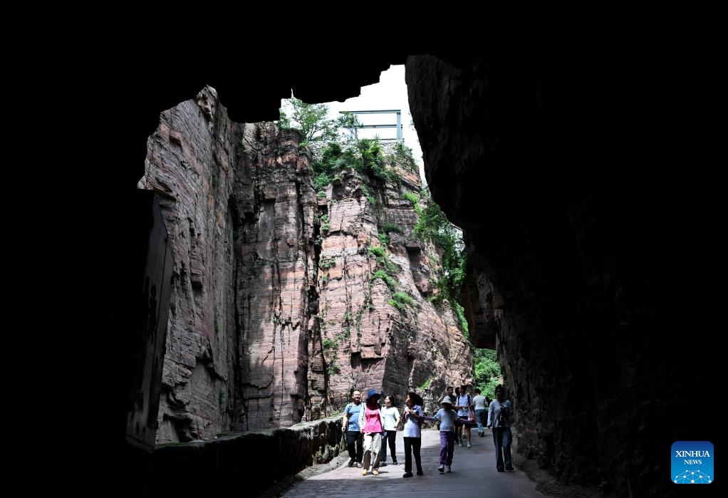 Tourists visit the Wanxianshan scenic area in Huixian City, central China's Henan Province, Aug. 16, 2025. The Wanxianshan scenic area, located deep in the Taihang Mountains and boasting its geological characters, attracts a lot of tourists in summer. (Xinhua/Zhu Xiang)
