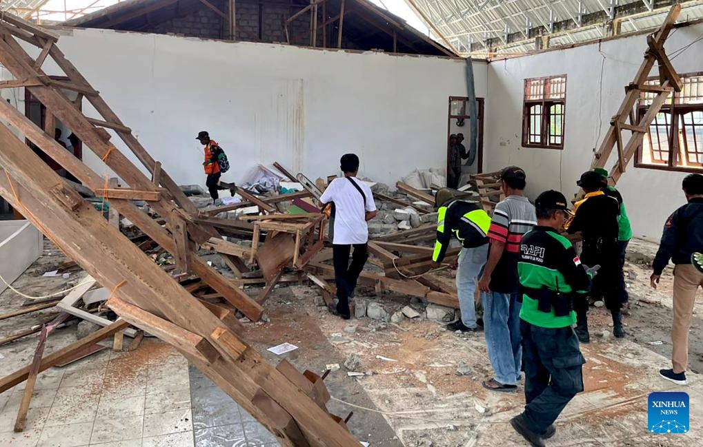 This photo taken with a mobile phone provided by Regional Disaster Management Agency (BPBD) Central Sulawesi shows officers inspecting a damaged building after an earthquake in Poso Regency, Central Sulawesi, Indonesia, on Aug. 17, 2025. (BPBD Central Sulawesi/Handout via Xinhua)