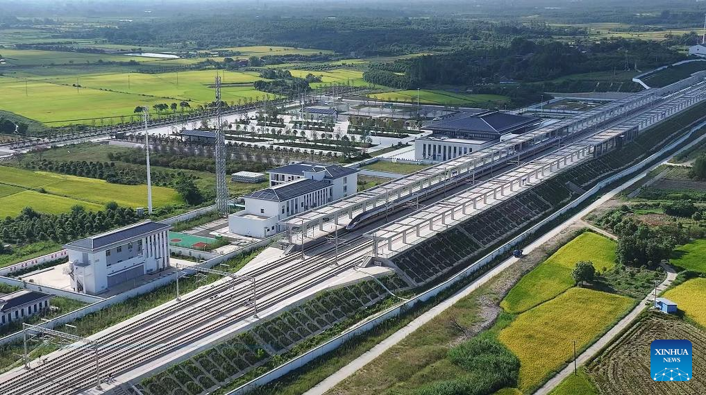 An aerial drone photo taken on Aug. 23, 2025 shows a test train running on the Xiangyang-Jingmen high-speed railway in central China's Hubei Province. The Xiangyang-Jingmen high-speed railway started test operation on Saturday. Connecting Xiangyang City of central China's Hubei Province in the north and Jingmen City of the province in the south, the 116.23-km-long railway with a designed speed of 350 kilometers per hour is an important section in one of the main passages of a greater high-speed rail artery network consisting eight vertical lines and eight horizontal lines in the country. (Photo by Chen Long/Xinhua)