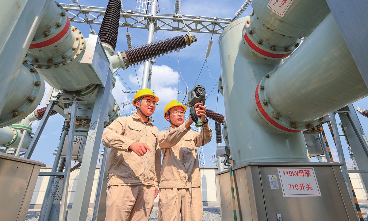 Workers of the State Grid Corp of China conduct infrared temperature inspections on a 110-kilovolt facility to identify hidden risks and ensure safe operation at a substation in Lianyungang, East China's Jiangsu Province, on August 21, 2025. Power use across the country hit 1.02 trillion kilowatt-hours in July, up 8.6 percent year-on-year, driven by a combination of multiple rounds of heatwaves and steady industrial activity, according to the National Energy Administration. Photo: cnsphoto
