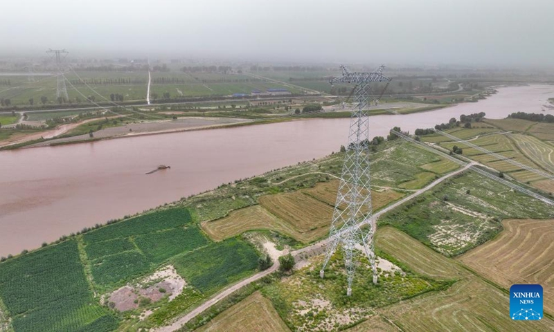 An aerial drone photo taken on Aug. 20, 2025 shows the direct current transmission lines, across the Yellow River, of the Ningxia-Hunan ±800 kV ultra-high voltage (UHV) direct current transmission project in Zhongwei City, northwest China's Ningxia Hui Autonomous Region.