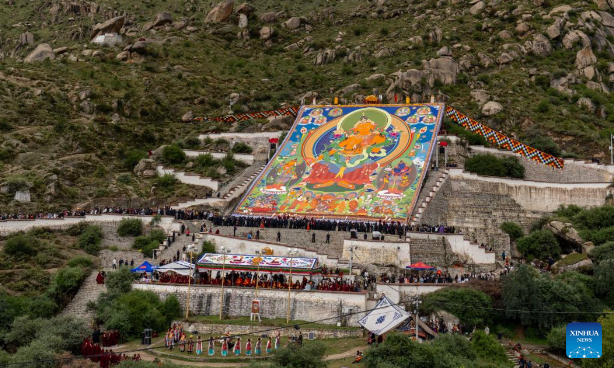 An enormous thangka painting of Buddha is unrolled on a hillside platform at the Drepung Monastery in Lhasa, southwest China's Xizang Autonomous Region, Aug. 23, 2025. Celebrations marking the traditional Shoton Festival began in Lhasa on Saturday. (Xinhua/Tenzing Nima Qadhup)