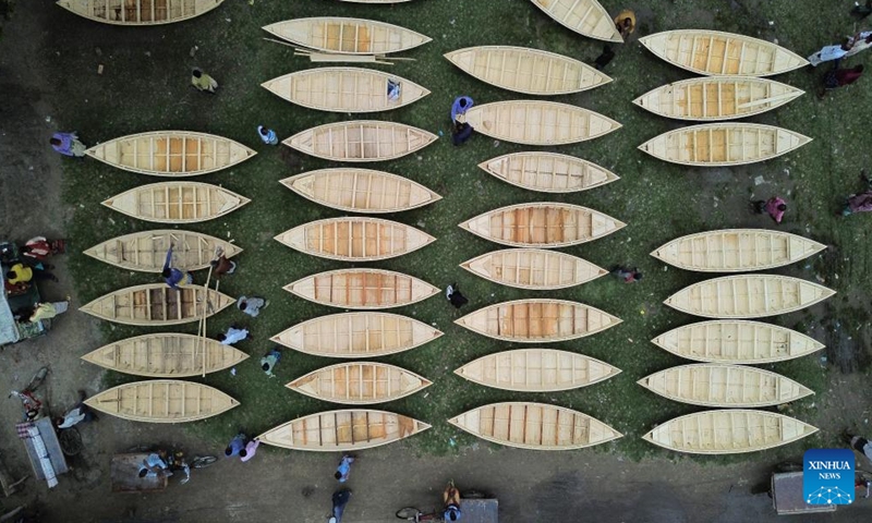 An aerial drone photo taken on Aug. 20, 2025 shows a local hand-made wooden boat market in Manikganj, Bangladesh. Waterways play a vital role in communications in Bangladesh, where traditional country boats and small vessels continue to offer affordable and convenient transport. (Photo by Habibur Rahman/Xinhua)
