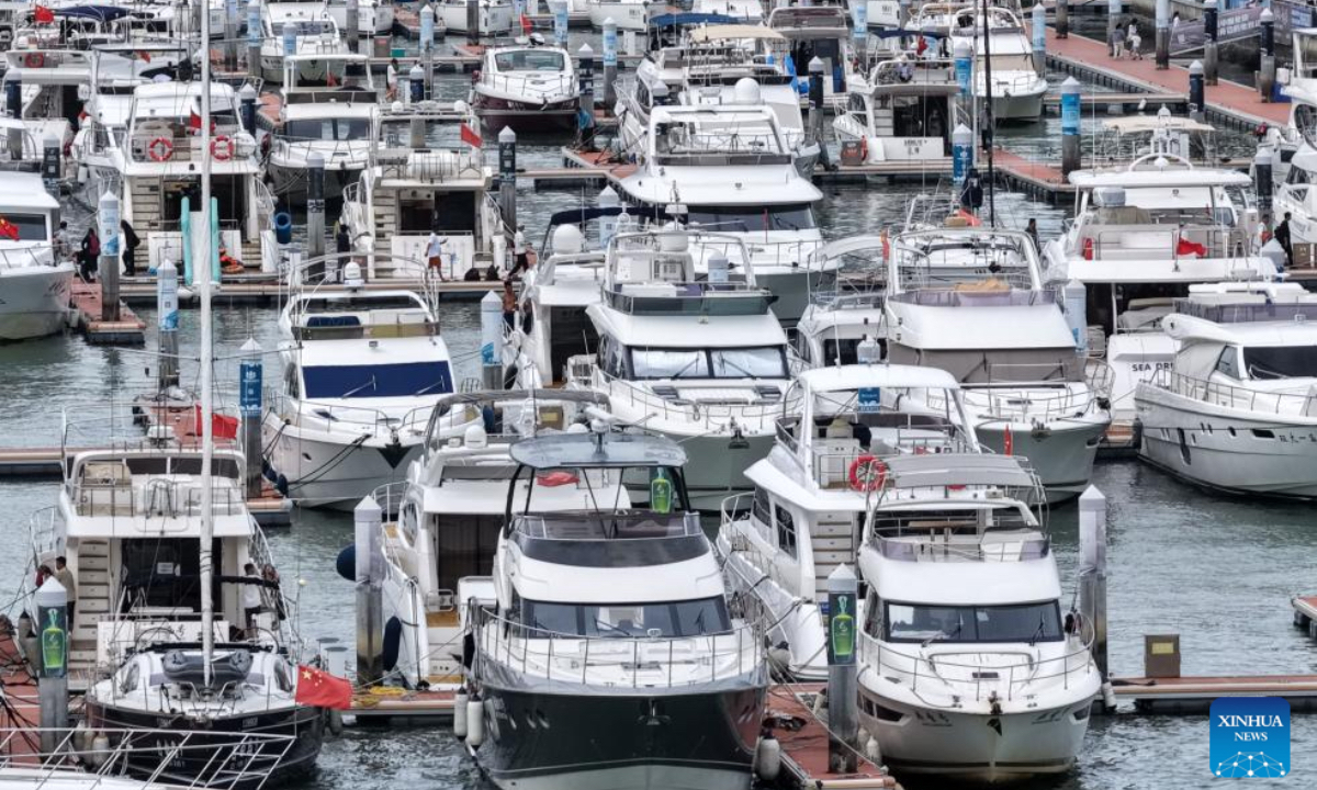 An aerial photo taken on Aug 23, 2025 shows yachts at a dock in Sanya, south China's Hainan Province. China on Saturday activated a Level-IV emergency response to flooding and typhoon in Hainan Province as Typhoon Kajiki, the 13th typhoon of this year, is approaching, according to the Ministry of Emergency Management. The State Flood Control and Drought Relief Headquarters has initiated emergency response measures and dispatched a work team to the southern province to assist with local flood and typhoon relief efforts, the ministry said. At 11 a.m. Saturday, the center of Typhoon Kajiki was located around 650 km east of Hainan's Sanya City over the sea, and it is forecast to move westward at a speed of up to 25 km per hour with its intensity expected to strengthen significantly, according to meteorological authorities. China's National Meteorological Center on Saturday issued a yellow alert for Typhoon Kajiki, warning that it is likely to make landfall or pass close to the southern coast of Hainan Island around Sunday evening. (Xinhua/Zhao Yingquan)