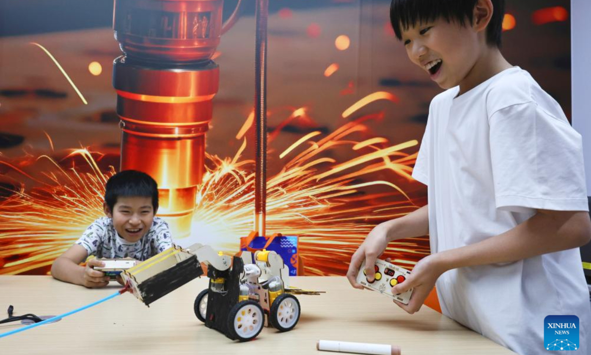 Children play a battle game with robots made by themselves at a science and technology training institution in Shanghai, east China, on Aug. 21, 2025. The summer vacation is coming to an end and children across the country have spent a wonderful holiday with diverse activities ranging from science and technology innovations to outdoor sports. (Xinhua/Fang Zhe)