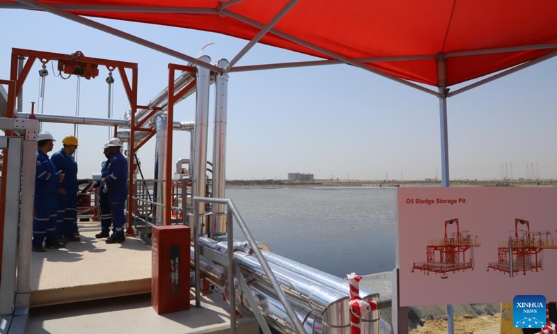 Workers are seen at an oil lake crude recovery project led by China's Jereh Group in Ahmadi Governorate, Kuwait, Aug. 20, 2025. Kuwait has kicked off a major environmental cleanup effort as the first unit of an oil lake crude recovery project led by Jereh completed its trial run Wednesday. (Xinhua/Yin Ke)