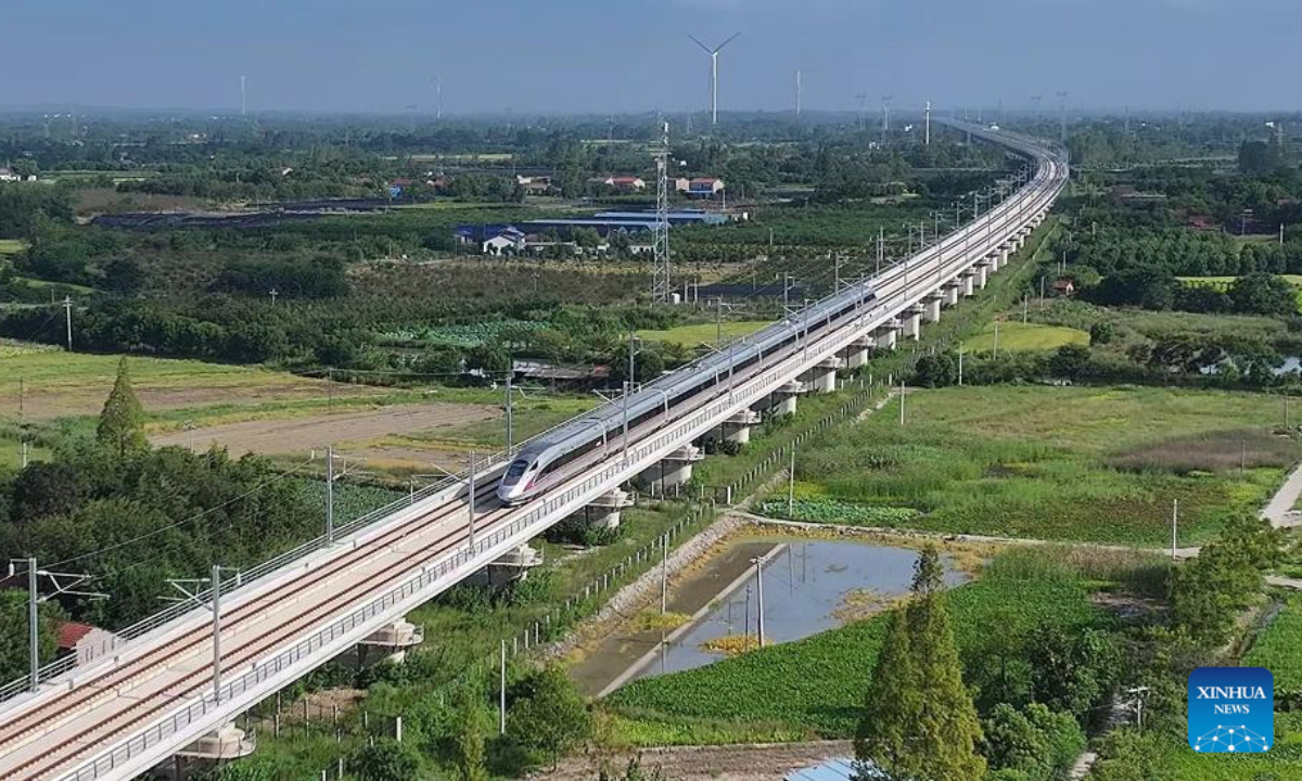 An aerial drone photo taken on Aug. 23, 2025 shows a test train running on the Xiangyang-Jingmen high-speed railway in central China's Hubei Province. The Xiangyang-Jingmen high-speed railway started test operation on Saturday. Connecting Xiangyang City of central China's Hubei Province in the north and Jingmen City of the province in the south, the 116.23-km-long railway with a designed speed of 350 kilometers per hour is an important section in one of the main passages of a greater high-speed rail artery network consisting eight vertical lines and eight horizontal lines in the country. (Photo by Chen Long/Xinhua)