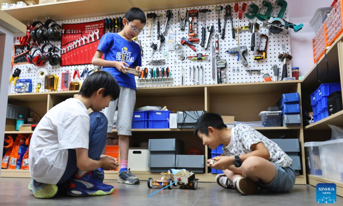 Children play robot battle games at a science and technology training institution in Shanghai, east China, on Aug. 21, 2025. The summer vacation is coming to an end and children across the country have spent a wonderful holiday with diverse activities ranging from science and technology innovations to outdoor sports. (Xinhua/Fang Zhe)