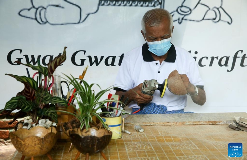 An artisan makes a coconut shell-based handicraft at a workshop in Yangon, Myanmar, Aug. 19, 2025. (Xinhua/Myo Kyaw Soe)