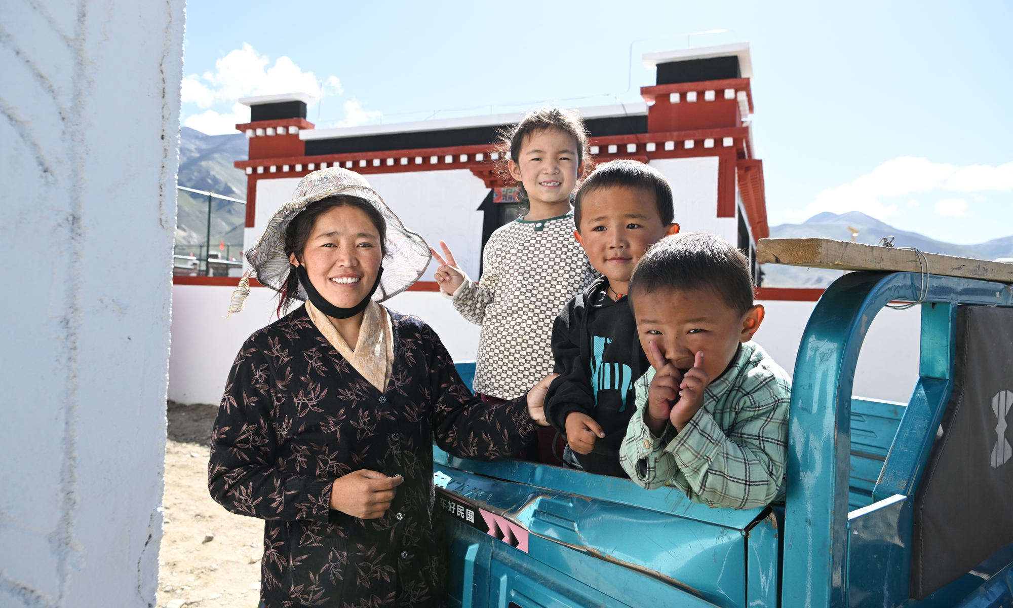 
A family stand at the entrance of their new house in Senga village during a move-in ceremony for earthquake-relief housing in Dingri county, Southwest China's Xizang Autonomous Region on August 15, 2025.