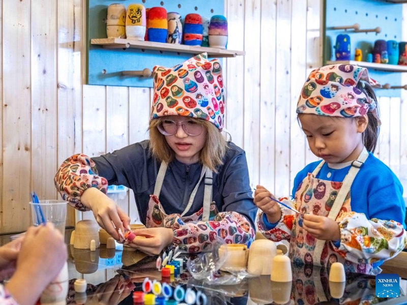 Tourists experience painting on Matryoshka dolls at Enhe Township of Hulun Buir, north China's Inner Mongolia Autonomous Region, on Aug. 21, 2025. Enhe, located in the northeastern corner of Inner Mongolia, is China's only Russian ethnic township that has for years drawn travelers seeking its inspiring blend of Chinese-Russian culture, hearty cuisine and sweeping natural vistas.

In recent years Enhe has attracted many tourists by promoting unique activities such as local family visiting, Russian bread making and Matryoshka doll painting.

The township, with a population of only about 2,900, received 615,000 visitors in 2024, who had brought in a gross tourism revenue of 92.25 million yuan (about 12.85 million U.S. dollars). Photo: Xinhua