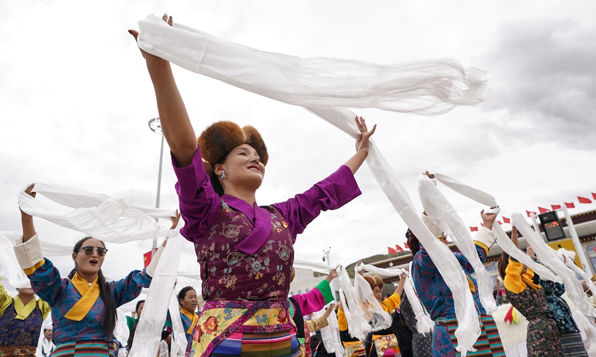 People take part in a grand mass parade during the 60th anniversary celebration of the founding of Southwest China's Xizang Autonomous Region at the Potala Palace Square in Lhasa on August 21, 2025.