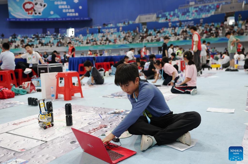Participants compete during the 2025 Junior Botball Challenge Global Finals in China in Beijing, capital of China, Aug. 21, 2025. The 2025 Junior Botball Challenge Global Finals in China kicked off on Thursday at the National Speed Skating Oval in Beijing. Nearly 1,500 young science and technology enthusiasts from more than ten countries and regions, including China, the United States, Malaysia, Thailand, Austria, and Slovakia, participated in the event. Photo: Xinhua