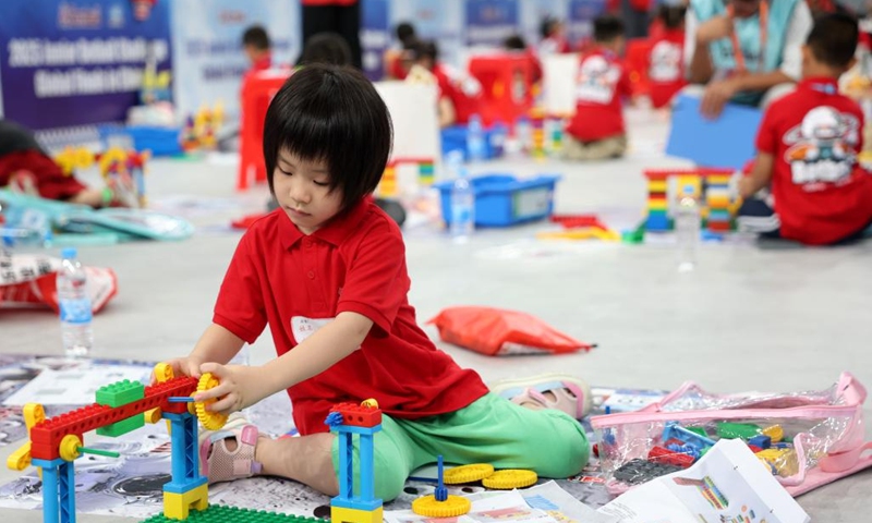 A participant competes during the 2025 Junior Botball Challenge Global Finals in China in Beijing, capital of China, Aug. 21, 2025. The 2025 Junior Botball Challenge Global Finals in China kicked off on Thursday at the National Speed Skating Oval in Beijing. Nearly 1,500 young science and technology enthusiasts from more than ten countries and regions, including China, the United States, Malaysia, Thailand, Austria, and Slovakia, participated in the event. Photo: Xinhua