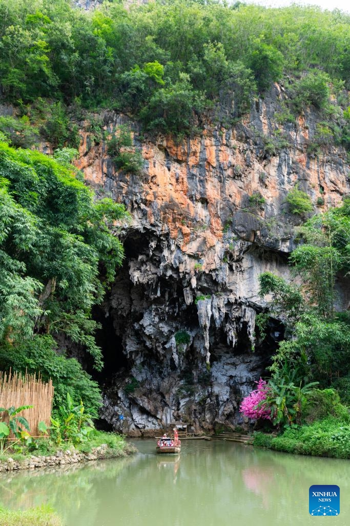 Tourists experience taking a boat in Bamei Village of Guangnan County, Wenshan Zhuang and Miao Autonomous Prefecture, southwest China's Yunnan Province, Aug. 25, 2025. In recent years, Bamei Village has developed local tourism utilizing its karst landscapes and cultural resources. A tourist resort which helps boost the local service sector has taken shape. (Xinhua/Gao Yongwei)