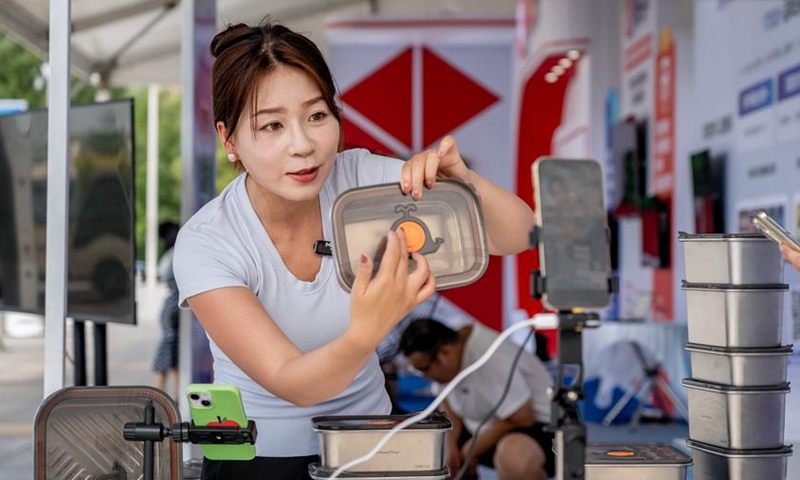 A woman promotes products via live-streaming at the 5th China new e-commerce conference in Yanbian Korean Autonomous Prefecture, northeast China's Jilin Province, July 27, 2025. (Xinhua/Tang Chengzhuo)