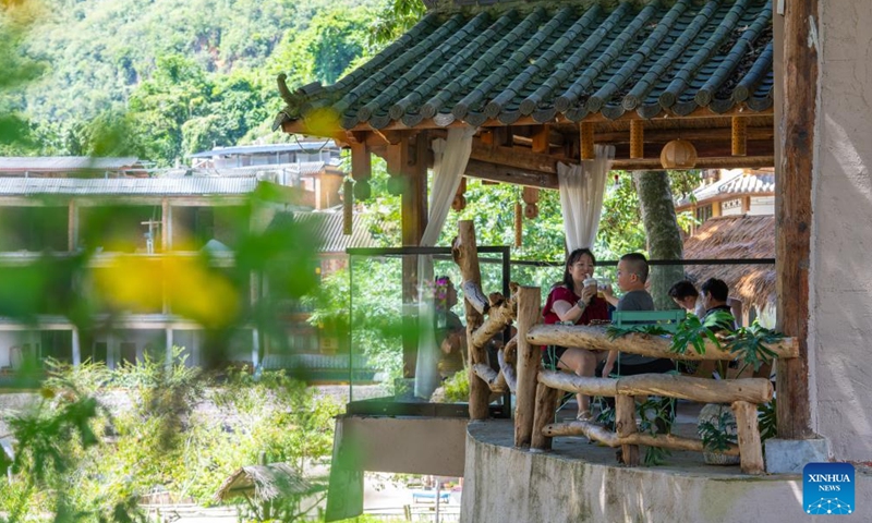 Tourists are seen at a cafe in Bamei Village of Guangnan County, Wenshan Zhuang and Miao Autonomous Prefecture, southwest China's Yunnan Province, Aug. 25, 2025. In recent years, Bamei Village has developed local tourism utilizing its karst landscapes and cultural resources. A tourist resort which helps boost the local service sector has taken shape. (Xinhua/Gao Yongwei)