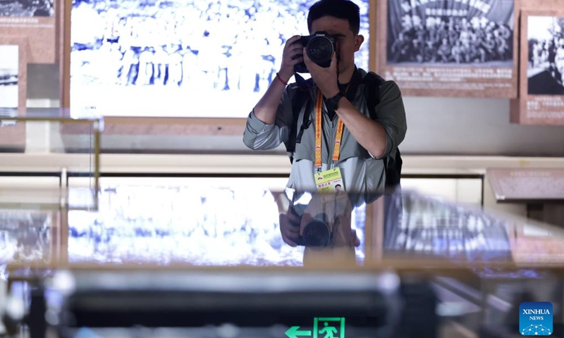 A journalist takes pictures during the visit to the Museum of the War of Chinese People's Resistance Against Japanese Aggression in Beijing, capital of China, Aug. 27, 2025. Nearly 200 journalists went to the Museum of the War of Chinese People's Resistance Against Japanese Aggression for visits and interviews on Wednesday.