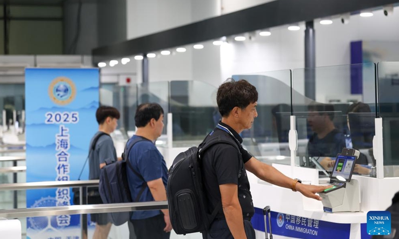 Travelers go through immigration inspection at Terminal 1 of Tianjin Binhai International Airport in north China's Tianjin, Aug. 27, 2025.