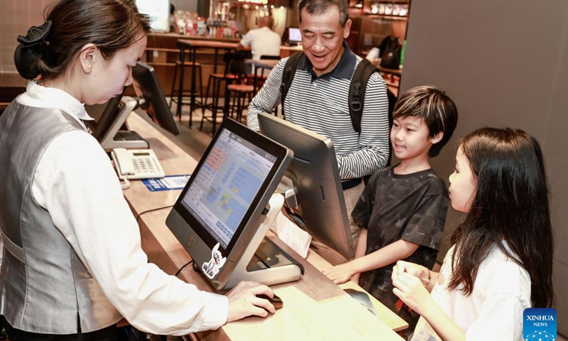 Audience buy tickets for Nobody, a spinoff from the acclaimed Yao-Chinese Folktales animation series, at a cinema in Wuhan, central China's Hubei Province, Aug. 25, 2025. China's summer box office revenue has surpassed 11 billion yuan (about 1.5 billion U.S. dollars) as of Sunday, with homegrown titles dominating the season's top earners. (Photo by Zhao Jun/Xinhua)