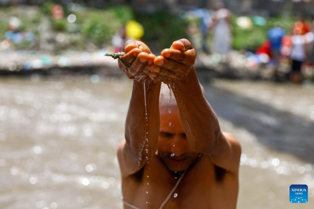A man performs a ritual during Kuse Aunsi, or Father's Day, at Gokarna Temple on the banks of the Bagmati River in Kathmandu, Nepal, Aug. 23, 2025.

Kuse Aunsi is a Hindu festival in which fathers, living or past, are honored. (Photo by Sulav Shrestha/Xinhua)