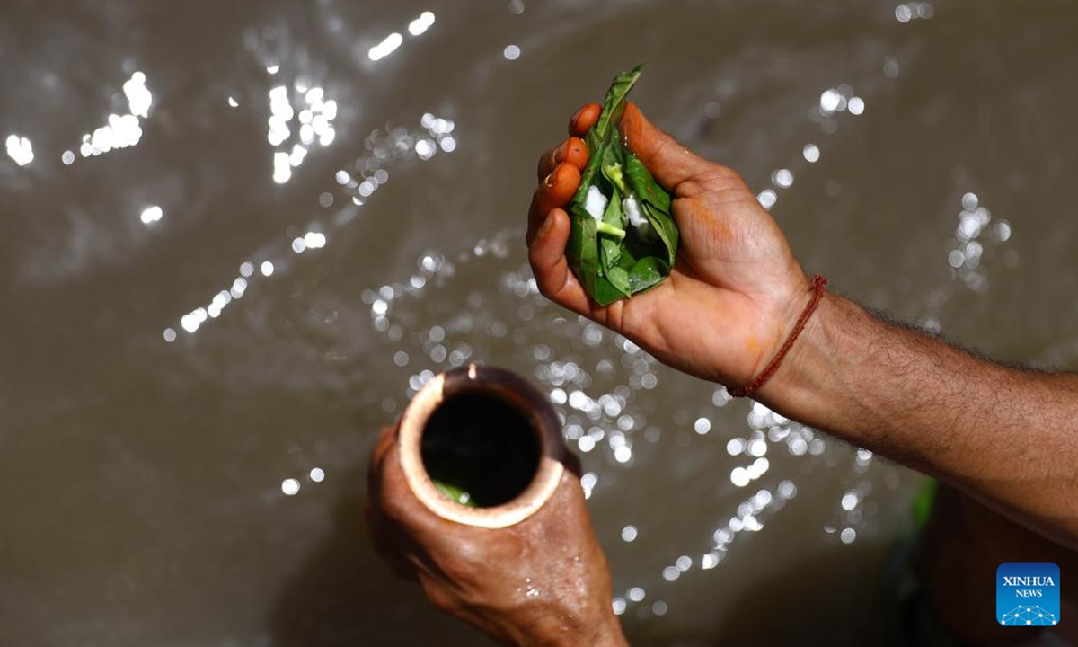 A man performs a ritual during Kuse Aunsi, or Father's Day, at Gokarna Temple on the banks of the Bagmati River in Kathmandu, Nepal, Aug. 23, 2025.

Kuse Aunsi is a Hindu festival in which fathers, living or past, are honored. (Photo by Sulav Shrestha/Xinhua)