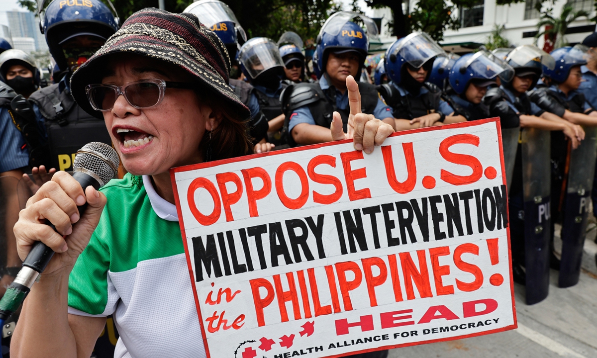 A protester holds a sign to protest against the Philippines-US Balikatan joint military exercises in Manila, the Philippines, on April 9, 2025. Photo: VCG