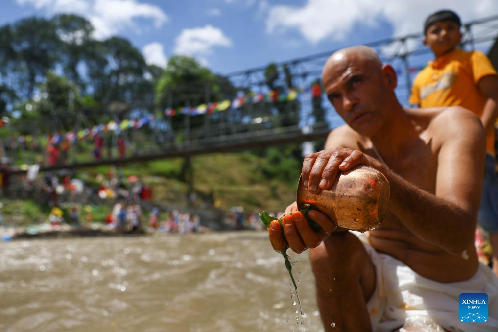 A man performs a ritual during Kuse Aunsi, or Father's Day, at Gokarna Temple on the banks of the Bagmati River in Kathmandu, Nepal, Aug. 23, 2025.

Kuse Aunsi is a Hindu festival in which fathers, living or past, are honored. (Photo by Sulav Shrestha/Xinhua)