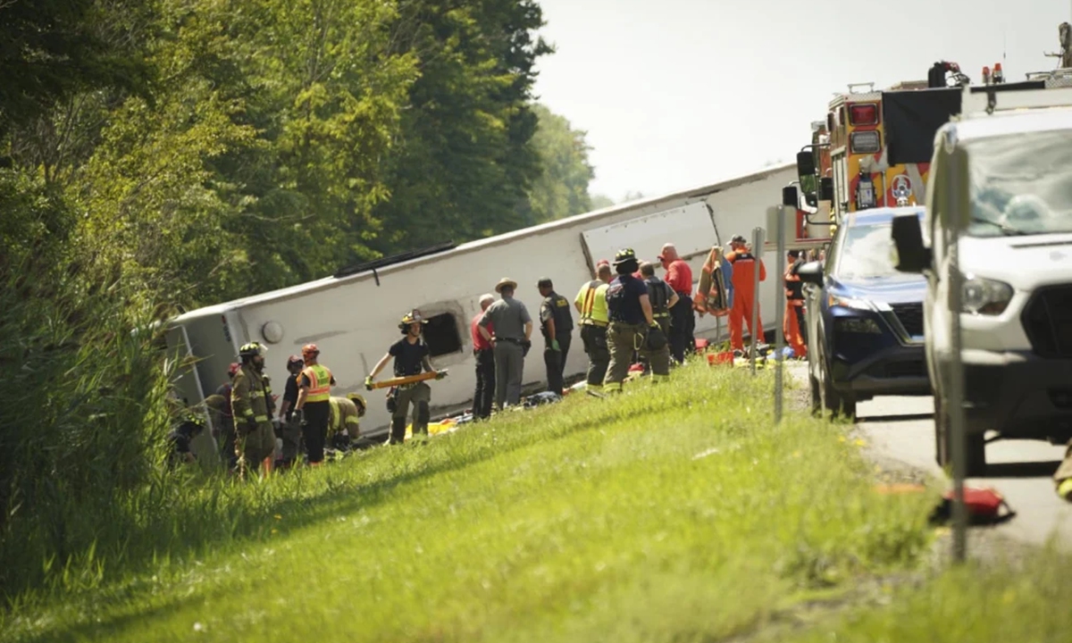 First responders work to rescue victims at the scene of a tour bus that crashed and rolled over Friday on the New York State Thruway near Pembroke, N.Y. Libby March. Photo: AP