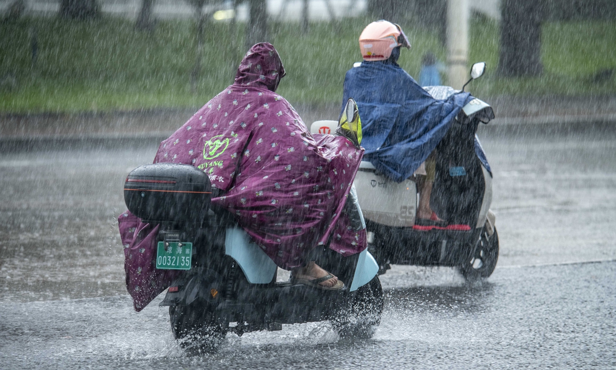 Residents of Qionghai city, Hainan Province, go about their daily business amid torrential rain on August 24, 2025. Under the influence of Typhoon Kajiki, the 13th typhoon of the year, most parts of South China's Hainan Province have been hit by heavy rainfall. Photo: VCG
