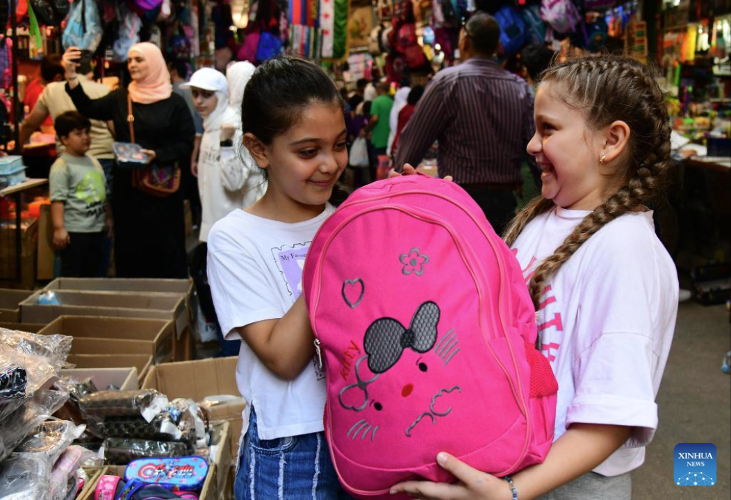 Girls shop for a schoolbag as the new school year approaches at a market in old Damascus, Syria, Sept. 17, 2025. (Photo by Ammar Safarjalani/Xinhua)