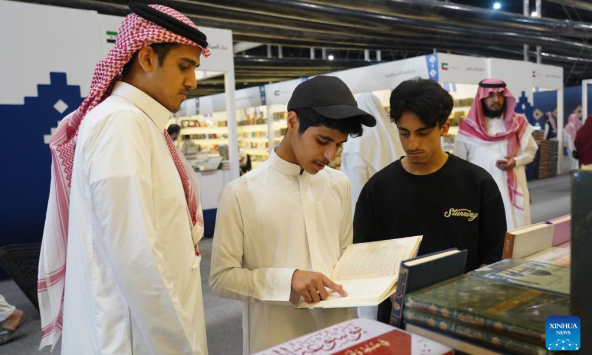 People read a book at the Riyadh International Book Fair 2025 in Riyadh, Saudi Arabia, Oct. 2, 2025. The book fair opened here on Thursday, bringing together over 2,000 local and international publishing houses from more than 25 countries, along with a range of cultural institutions. (Xinhua/Luo Chen)