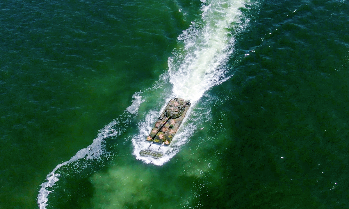 Amphibious armored infantry fighting vehicles (IFVs) attached to a brigade under the Chinese PLA Army maneuver towards the designated sea area during a ferrying and assault wave formation training exercise. (eng.chinamil.com.cn/Photo by Zhang Mao)