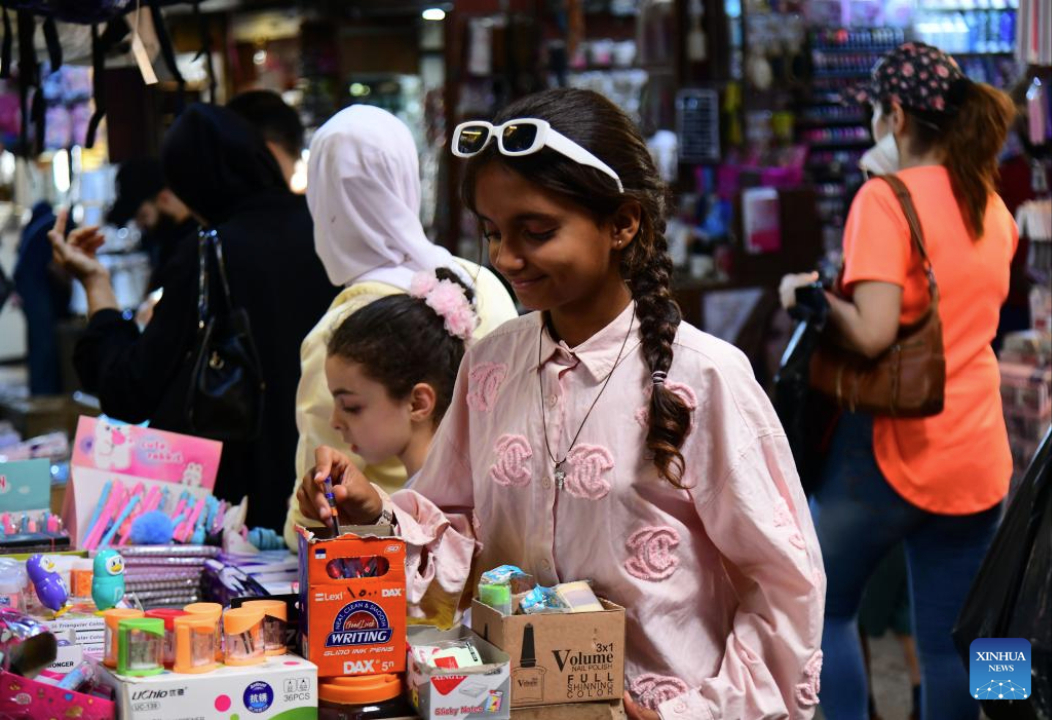 Girls shop for a schoolbag as the new school year approaches at a market in old Damascus, Syria, Sept. 17, 2025. (Photo by Ammar Safarjalani/Xinhua)